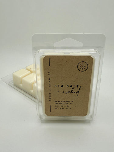 Packaged sea salt and orchid wax melts with a clear plastic wrap on a white background.